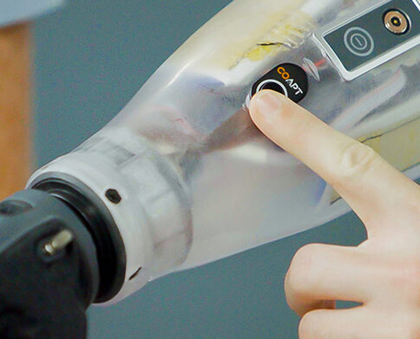 A Coapt user pressing the button on their prosthesis to calibrate the movement.